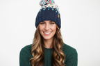 Woman's knitted winter beanie hat with pom pom